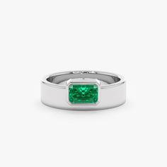 Geneva Unveil your bold style with the Off-Center Emerald Statement Ring. This eye-catching ring showcases a vibrant natural emerald, the May birthstone, in a captivating off-center setting. Crafted in lustrous 14k or 18k solid gold, the thick band adds a contemporary touch while maintaining minimalist elegance. - Handmade- Solid Gold- Natural Emerald- Total Emerald Carat Weight: 0.49 ctw- The Height of the Setting: 2.93 mm- Width of the Setting with the Band: 7.12 mm- The Width of the Band: 5.7 Modern Emerald Baguette Cut Ring, Formal Octagon Emerald Ring May Birthstone, Formal Octagon Emerald Ring For May Birthstone, Modern Emerald-cut Green Diamond Ring, Modern Emerald Cut May Birthstone Jewelry, Emerald Solitaire Ring In Fine Jewelry Style, Emerald Solitaire Ring Fine Jewelry, Fine Jewelry Emerald Solitaire Rings, Modern Green Rings With Prong Setting