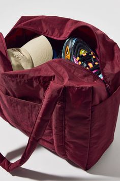 a large red bag filled with items on top of a white table