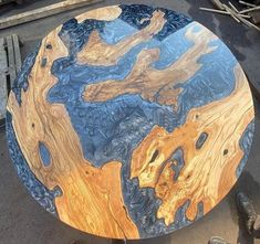 a table made out of wood with blue and yellow paint on it's surface