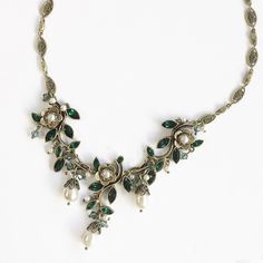 "This winding vine creates a neo-romantic look infused with the essence of mid-century American style. Its graceful links are set with premium emerald green marquis cut crystal. Pearl beads and drops dangle below Hand burnished bronze. Length: 17\" plus 4\" extender. Made at Sweet Romance in our Los Angeles studio. Free shipping." Emerald Statement Necklace, Neo Romantic, Emerald Green Crystal, Necklace Emerald, Fairy Jewelry, Turquoise Accents, Mid Century Jewelry, Sweet Romance, Green Jewelry