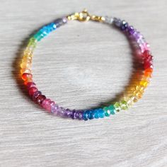 This rainbow bracelet has a great variety of natural gemstones. They are : Aquamarine, raw Ruby, Garnet, Amethyst, Iolite, Peridot, Citrine, Carnelian, Tourmaline, Apatite , blue sapphire rock Quartz, Tanzanite and emerald A gorgeous fusion of colors in this multi stone precious  bracelet. A riot of vivid  colors  in ombre design I chose and  lined the gemstones to obtain this unique shaded colorful precious bracelet. It will be beautiful alone or together with other gemstones stacking bracelets Rainbow Natural Stones Beaded Bracelets For Jewelry Making, Rainbow Gemstone Beads Bracelets For Jewelry Making, Rainbow Gemstone Beads Bracelets For Healing, Multicolor Gemstone Bracelets For Healing, Spiritual Multicolor Faceted Beaded Bracelets, Rainbow Bracelet Jewelry For Healing, Rainbow Crystal Bracelet With Natural Stones For Healing, Multicolor Faceted Rondelle Bracelets, Multicolor Crystal Gemstone Bracelet For Healing