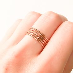 * For your comfort we recommend going up 1/2 size if you are planning on wearing 5 or more rings on one finger. * Set of 5 14K rose gold filled stackable rings. * Made out of 14K rose gold filled 18 gauge round wire (approx. 1 mm wide before texturing). * Our jewelry is packaged in a cute box ready for gift giving. You can also request a personal message which we hand write onto a gift tag. We try to package responsibly in an effort not to waste. Often more than one item with be placed in the sa 14k Rose Gold Stackable Promise Rings, 14k Rose Gold Stackable Rings, Delicate Rose Gold Stackable Midi Rings, Delicate Rose Gold Stackable Rings With Round Band, Adjustable 14k Rose Gold Stackable Rings, Hypoallergenic Rose Gold 14k Stackable Rings, Hypoallergenic 14k Rose Gold Stackable Rings, Delicate Hypoallergenic Rose Gold Midi Rings, Rose Gold Stackable Midi Promise Rings