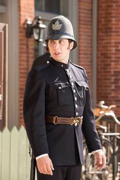 a man in uniform standing next to a bike