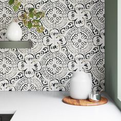 a kitchen counter with two vases on it