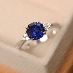 This ring features a 7*7 mm octagon cut lab sapphire. Customization is available. It is made by hand, and it will take about 7 days to finish the ring after your payment is completed. Main stone: 7*7 mm octagon cut lab sapphire Main stone weight: 1.91 ct Metal type: sterling silver /14k gold Accent stone: cz Customization is available, just fee free to contact me, it is free to engrave inside the ring, it is free, you can leave a ntoe with your order, but it will be great no more than 15 letter. Blue Sapphire Promise Ring, Heart Cut Ring, Moonstone Engagement Ring Rose Gold, Sapphire Promise Rings, September Birthstone Ring, White Gold Sapphire Ring, Original Engagement Rings, September Birthstone Rings, Blue Gemstone Rings