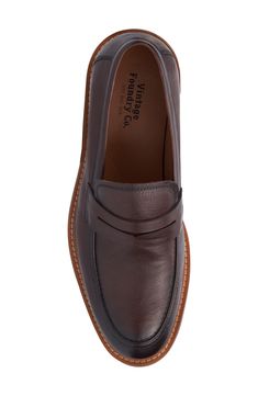 A classic penny keeper distinguishes this leather loafer for a timeless well-dressed staple. Lace-up style Cushioned insole Leather upper/leather and textile lining/rubber soe Imported Vintage Slip-on Loafers For Work, Derby Round Toe Loafers With Leather Lining, Derby Loafers With Leather Lining And Round Toe, Round Toe Loafers For Derby, Office Leather Moc Toe Shoes, Classic Brown Leather Slip-on Shoes, Vintage Leather Sole Moccasins For Business, Vintage Brown Slip-on Loafers, Vintage Brown Moccasins For Workwear