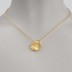 Capture nature's beauty with our dainty Italian 14k or 18k gold heart pendant and chain. Exquisitely small and adorned with a delicate leaf motif, this pendant is a wearable piece of art that symbolizes love and connection. Meticulously crafted in Italy, the intricate details and fine craftsmanship make this tiny heart pendant a cherished expression of elegance and nature's grace. 14k or 18k gold 16mm high 15mm large 18k Rolò chain chain length 45cm chain thickness 1.5mm designed and crafted in Yellow Gold Leaf-shaped Jewelry Gift, Elegant Yellow Heart Pendant Necklace, Intricate Heart Pendant In Yellow Gold, Leaf-shaped Yellow Gold Necklace For Gift, Heart-shaped Yellow Gold Brass Necklace, Leaf Motif, Heart Pendant Gold, Italian Jewelry, Gold Heart Necklace