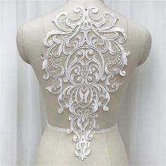 the back of a mannequin with an intricate design on it's chest