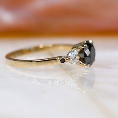 an engagement ring with a black and white diamond