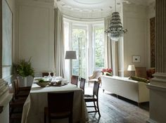 a living room with a couch, table and chairs