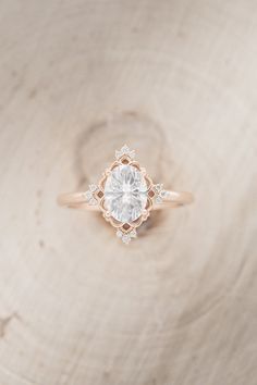 an engagement ring on top of a piece of wood