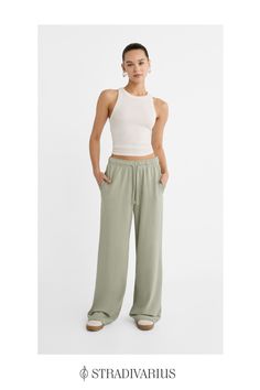 Flowing long trousers with a straight and wide leg design. Elastic waist and with adjustable matching drawstrings. Side pockets. Available in several colours. Athleisure Straight Pants With Elastic Waistband, Wide Leg Joggers With Drawstring For Loungewear, Casual Wide Leg Loungewear Pants, Straight Leg Joggers For Loungewear, Trendy Straight Leg Joggers For Loungewear, Relaxed Straight Leg Sweatpants With Ribbed Waistband, Relaxed Straight Leg Joggers With Elastic Waistband, Relaxed Style Sweatpants With Loosely Fitted Hips, Casual Joggers For Loungewear With Elastic Side Panels