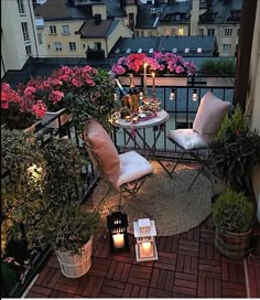 the balcony is decorated with potted plants, candles and other things to enjoy in