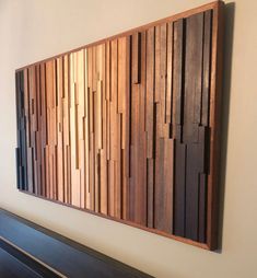 a wooden wall hanging on the side of a white wall