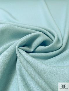 a close up shot of a light blue fabric