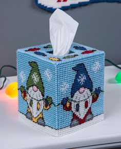 a tissue dispenser sitting on top of a table next to a christmas ornament