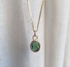 This minimalist Green Tourmaline, solid gold necklace was designed with a bottle green see through pendant, to beautifully accompany you through your busy days. The classic simple design is always pretty for day and evening, work or fun. The gold Tourmaline necklace is handmade and delicate and available both with a 9kt or a 14 karat pendant. The solid gold chain is made of 14k and available in a of couple lengths. The clear Green Tourmaline necklace is a perfect chic and elegant gift. The penda Green Pendant Necklace Gold, Minimalist Yellow Gold Emerald Necklace For Gift, Minimalist Green Emerald Necklace For Everyday, Everyday Minimalist Green Emerald Necklace, Minimalist Emerald Necklace With Round Pendant, Minimalist Emerald Birthstone Necklace With Round Pendant, Minimalist Everyday Emerald Birthstone Necklace, Everyday Minimalist Emerald Birthstone Necklace, Minimalist Emerald Pendant Necklace As Birthstone