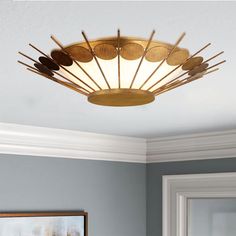 a ceiling light that is hanging from the ceiling in a room with blue walls and white trim