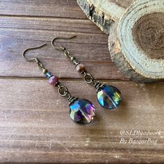 Crystal earrings boho rainbow tourmaline handmade purple round dangle bronze boho style festival gift her unique jewelry earrings for women Earrings for women. Yes, please. I love to rock a great pair of earrings. Stone, crystal, lampwork, beaded earrings, well I love all of them! These earrings have 18mm rainbow crystal faceted round drops, 6mm tourmaline gemstone, 4mm Swarovski Crystal aurora beads, bronze findings and ear wire. Can't find your stone or color? I specialize in hard to find uniq Iridescent Round Bohemian Jewelry, Bohemian Iridescent Round Jewelry, Iridescent Bohemian Earrings As Gift, Iridescent Bohemian Earrings For Gifts, Handmade Bohemian Brass Crystal Earrings, Multicolor Bohemian Crystal Earrings, Bohemian Wire Wrapped Round Crystal Earrings, Purple Bohemian Crystal Earrings As A Gift, Bohemian Wire Wrapped Bronze Earrings