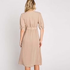 Elevate your wardrobe with our Asymmetrical Button-Down Wrapped Midi Dress, a true embodiment of timeless elegance and style. This dress offers a perfect blend of sophistication and modern flair, ensuring you'll look effortlessly chic and feel confident on any occasion. Key Features: Half-Sleeve Design: The dress features a half-sleeve with button closure, providing a touch of modesty and versatility. You can adjust the sleeves to your preference, making it suitable for various weather condition Classic V-neck Midi Dress With Buttons, Fitted V-neck Midi Dress With Button Cuffs, Fitted Button Back Midi Dress For Daywear, Fitted Midi Dress With Button Back For Daywear, Elegant Rayon Shirt Dress For Daywear, Feminine Fitted Midi Dress With Buttons, Belted Midi Dress With Asymmetrical Hem For Summer, Summer Midi Dress With Belted Asymmetrical Hem, Elegant Midi Length Rayon Shirt Dress