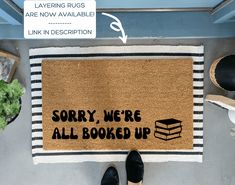 a door mat that says sorry we're all booked up on the floor