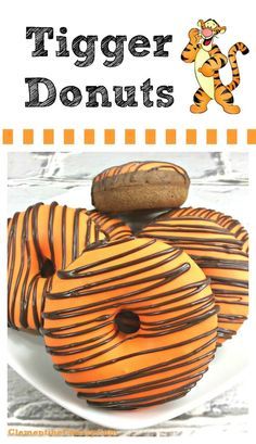 tiger donuts on a white plate with chocolate drizzled on them and the words tiger donuts above it