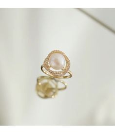 Live your vintage inspired dreams with our pearl and diamond ring. With the pearl bead in the middle and CZ Diamonds surrounding this is the perfect romantic gift for an engagement ring.• Material: High Quality 14K Gold Plated• Finish: 14K Gold Big Pearl Ring, Engagement Rings Romantic, Precious Stones Rings, Unusual Rings, Handmade Engagement Rings, Pearl And Diamond Ring, Big Pearl, Gothic Accessories, Pearl Diamond