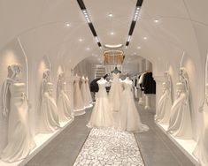 there are many white dresses on display in the store's showroom, including mannequins and gowns