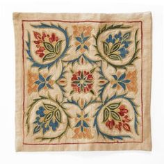 an embroidered square with flowers and leaves on the front, is shown in beige linen