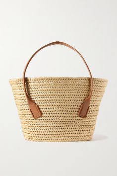 Bottega Veneta's tote is the ideal vacation accessory - the open-top is perfect for propping your towel and inside, there's enough room for your beach read, sunglasses and SPF. It's crafted from beige raffia with a tan leather trim and long shoulder straps. Designer Straw Bag With Handles For Vacation, Designer Straw Bag For Vacation, Luxury Beach Bag For Vacation, Designer Straw Tote Bag For Vacation, Designer Natural Straw Bag For Travel, Designer Beach Straw Bag, Designer Straw Bag For The Beach, Designer Summer Straw Bucket Bag, Luxury Summer Bag With Leather Trim