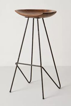 a wooden stool with metal legs on a white background