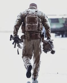 a man in uniform walking down the street