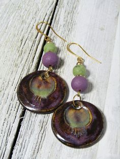 "These are stunning HAND-MADE CERAMIC CHARMS made by an artist in Spain. The charms are 30mm in diameter and LOVE the colors: from BROWN to PURPLE to GREEN to GOLD. These are combined with 10mm matte purple rounds and 6mm matte olive green rounds. Brass finding and spacers and gold-plate ear wires. They are roughly 3\" long with a 2..\" drop. Absolutely DELICIOUS colors and truly one of a kind! Just one pair." Artistic Czech Glass Earrings Gift, Artistic Czech Glass Earrings For Gifts, Artsy Teardrop Jewelry With Matching Earrings, Artsy Czech Glass Dangle Jewelry, Handmade Spiritual Czech Glass Earrings, Artisan Czech Glass Earrings As Gift, Artistic Round Beads Earrings As A Gift, Purple Artisan Earrings With Ear Wire, Artistic Round Bead Earrings For Gifts