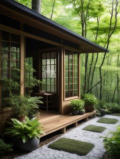 a small wooden house in the middle of a forest with plants and rocks on the ground