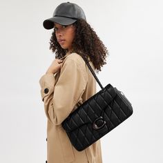 A modern take on an archival 1970s Coach design our structured Tabby shoulder bag is crafted of luxe quilted nappa leather. Finished with our Signature hardware for an iconic touch the 33 is a spacious style with a secure inside zip pocket a convenient outside pocket and plenty of room for essentials including a mini tablet. Keep the leather-and-chain strap long to wear it crossbody or double it for a shorter dressier look. | Coach Tabby Shoulder Bag 33 With Quilting - Women's - Pewter/black Luxury Handbags Coach, Coach Handbags Coach, Coach Bags 2021, Coach Bags Handbags Coach, Trendy Coach Shoulder Bag, Coach Hamdbags, Coach Pillow Tabby Purse, Coach Pillow Tabby Gray, Coach Pillow Tabby Vanilla