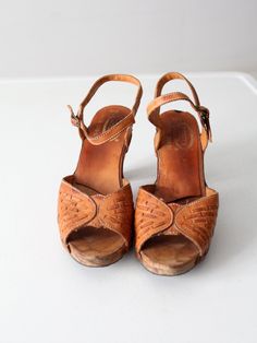 This is a pair of 1970s vintage Nobil's leather sandals. The brown leather open toe slingbacks have wooden heels. Buckle closure at ankle. Marked Made in Brazil.CONDITIONIn good condition with wear consistent with age and use. Small chip in the wood at the top of the heels. APPROXIMATE FIT: 10B USMEASUREMENTSInsole Length: 10.5" .. 26.7 cmWidth: 3" .. 7.6 cmHeel: 3.75" .. 9.5 cm92225Women’s sandals. Good condition, size 10. Detailed measurements:Length Of Sole - 10.5 inchesHeel Height - 3.75 inches Vintage Leather Open Toe Sandals, Vintage Brown Sandals With Wooden Heel, Retro Brown Leather Sandals, Retro Brown Clogs For Summer, Brown Retro Summer Clogs, Vintage Brown Sandals With Round Toe, Vintage Brown Open Toe Clogs, Retro Leather Sandals With Wooden Heel, Retro Sandals With Wooden Open Heel