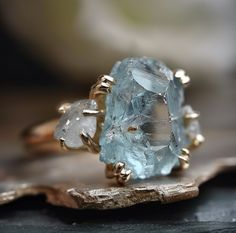 This is a ring made with raw Aquamarine and clear quartz, if you want switch clear quartz to raw diamond, please message/email me.  Aquamarine size: 8-15mm You will receive one of the pieces pictured above, or a piece nearly identical to the rings above. Since each gemstone is one-of-a-kind, I cannot guarantee that the Raw Moonstone, Herkimer Diamond Ring, Raw Aquamarine, Multiple Rings, Aquamarine Engagement Ring, Studded Necklace, Raw Diamond, Diamond Gold, Wedding Matches