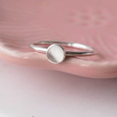 ** Order before 17th December for Christmas Delivery (UK ONLY ) ** Sterling Silver and Moonstone Birthstone ring. Made from a band of 1.5mm round sterling silver wire, with a 5mm round Moonstone. The moonstones used are an opaque milky white. Beautifully simple. Polished silver finish. Other Custom Birthstone Rings are also available- message or press the Custom Order button! You can wear this ring with other rings from my collection to make your own stacking ring set. -Sterling Silver - 5mm siz Moonstone Birthstone, Custom Birthstone Ring, Jewellery Maker, Birthstone Rings, June Birthstone Jewelry, Stacking Ring Set, Scotland Uk, White Moonstone, Moonstone Jewelry