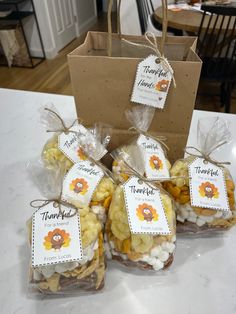 four bags filled with treats sitting on top of a table