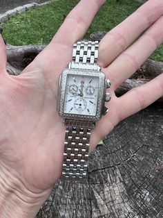 "This elegant MICHELE Diamond Chronograph watch  comes from their Deco collection.  The stainless steel watch reflects the  geometric shapes identified with Art Deco architecture.       The attractive timepiece features a rectangular shape studded with 108 diamonds.   The diamonds have a total weight of .60 ct.  The diamonds are H in color and VS1 in clarity. The Swiss chronograph watch also features a stainless steel bracelet. It is marked Michele, MW06A01A1025, .60 ct, 108 dia, stainless steel Elegant Business Chronograph Watch With Rectangular Dial, Modern Diamond Watch Accessories For Formal Occasions, Modern Watch With Diamond Accents And Rectangular Dial, Modern Diamond Watch With Rectangular Dial And Diamond Accents, Modern Silver Diamond Watch With Diamond Accents, Elegant Business Chronograph Watch With Diamond Hour Markers, Designer Rectangular Diamond Watch For Anniversary, Silver Rectangular Diamond Watch For Formal Events, Designer Rectangular Watches For Anniversary