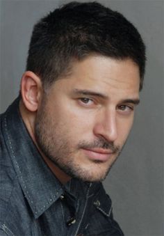 a black and white photo of a man with a goatee hairstyle looking at the camera