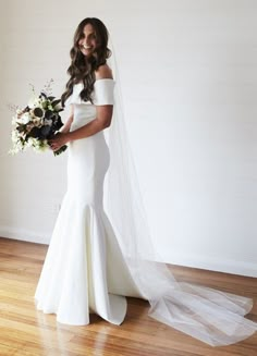 a woman in a wedding dress holding a bouquet