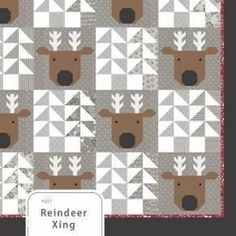 the cover of reindeer king quilt pattern is made with grey and white squares, which have brown moose heads on them