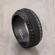 a black diamond ring on top of a wooden table