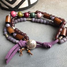 Acai beads in colors of plums and teals with Indonesian glass beads and buri beads with a purple faux suede and hill tribe button closure ⚫Walk on the Wild Side collection: When I first started making jewelry, I fell in love with Tagua nut. I love the shiny bright colors and smooth texture. I also fell in love with Karen Hill Tribe Silver Beads. In this collection each piece is either made from Tagua Nut, Karen Hill Tribe Silver, or both. Your jewelry will come in its own anti-tarnish zip lock b Handmade Bohemian Purple Wrap Bracelet, Purple Handmade Bohemian Wrap Bracelet, Purple Beaded Bohemian Wrap Bracelet, Bohemian Multi-strand Purple Beaded Bracelets, Purple Multi-strand Beaded Bohemian Bracelets, Purple Multi-strand Bohemian Beaded Bracelet, Bohemian Purple Multi-strand Beaded Bracelets, Handmade Purple Multi-strand Bracelets, Handmade Purple Multi-strand Bracelet