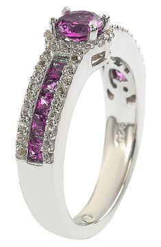 White created sapphires frame elegant pink sapphires that add a special touch to this unique sterling silver bridal ring. Sterling silver/sapphire Imported Luxury Pink Sapphire Ring With Pave Setting, Luxury Pink Sapphire Ruby Ring, Formal Pink Sapphire Diamond Ring With Halo Setting, Pink Sapphire Ring With Pave Setting, Exquisite Pink Sapphire Ring, Sterling Silver Sapphire Ring With Pave Setting, Luxury Pink Sapphire Ring With Halo Setting, Luxury Pink Sapphire Jewelry For Anniversary, Dazzling Sapphire Ring With Pave Setting