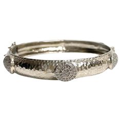 Description Your style comes to life wearing this unique, edgy and timeless sterling silver bracelet. Raised circle appliques totaling 2.20 carats of pave diamonds encircle and embellish this stunning bangle. Artistically hammered by hand to create dazzling reflections when catching the light, it is sure to be a fashion-forward addition to your jewelry wardrobe. Along with its beauty, this hinged bracelet features a discrete and secure clasp. Item # B1203 If you prefer a narrow bangle, see Item Bangle With Diamonds, Diamonds Bracelet, Newport Beach California, Jewelry Wardrobe, Circle Diamond, Hinged Bracelet, Silver Bangle, Beach California, Newport Beach