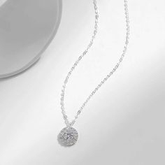 Enhance your style with our dazzling Olivia necklace, featuring a sparkling zircon pendant. Add a touch of elegance and glamour to any outfit with this eye-catching accessory. Elevate your look and make a statement with Olivia. White Gold Bling Pendant Necklace, Cubic Zirconia Round Pendant Necklace With Bling, Diamond Necklace With Bling Round Pendant, Diamond Necklaces With Round Pendant And Bling, Diamond Necklace With Round Pendant And Bling, Silver Cubic Zirconia Necklace With Bling, White Gold Necklace With Bling And Round Pendant, Elegant Crystal Clavicle Chain Necklace, Elegant Crystal Solitaire Necklace With Diamond Accents