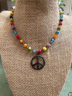 "The Happy Hippie Necklace is handbeaded with colorful Millefiori Italian Glass beads and Czech Glass beads.  Vintage Spirit Design Jewelry incorporates vintage elements into all of our jewelry. This is our way of recycling and reusing many beautiful pieces of jewelry that served their purpose in one form.  The Peace Sign Pendant on this necklace is 1\" in diameter.  The necklace comes in Silver or Antique Bronze. The hardware matches the metal of the Peace sign - so please choose which one you Cheap Adjustable Jewelry With Peace Sign, Cheap Colorful Hippie Beads, Hippie Colorful Beaded Necklaces Gift, Hippie Style Colorful Beaded Necklaces Gift, Colorful Hippie Round Bead Jewelry, Colorful Czech Glass Beaded Necklaces For Gifts, Hippie Style Colorful Round Bead Jewelry, Multicolor Tiny Beads Jewelry For Birthday, Bohemian Colorful Beads Jewelry For Birthday