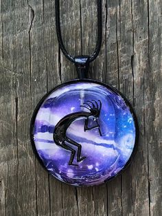 "Kokopelli Pendant Clear Quartz Kokopelli \" Cave Art\" Pendant over Original Gelli Print Art Kokopelli embedded in bezel with UV Resin Leather Adjustable Choker is 18 inches long" Adjustable Wearable Art Jewelry With Artistic Design, Artistic Hand Painted Purple Jewelry, Adjustable Hand Painted Spiritual Necklaces, Artistic Nickel-free Purple Jewelry, Adjustable Round Necklace With Artistic Design, Artistic Purple Nickel-free Jewelry, Round Adjustable Artistic Design Necklace, Artistic Adjustable Necklace, Artistic Round Adjustable Necklaces